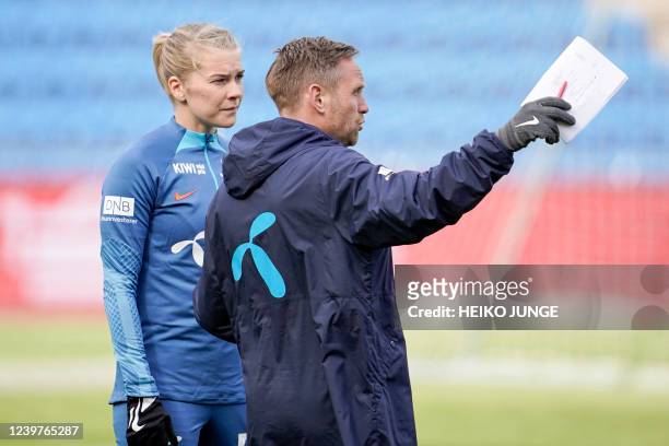 Norway's Ada Hegerberg and Norway's coach Martin Sjogren talk during a training session of the women's national football team of Norway at Ullevaal...