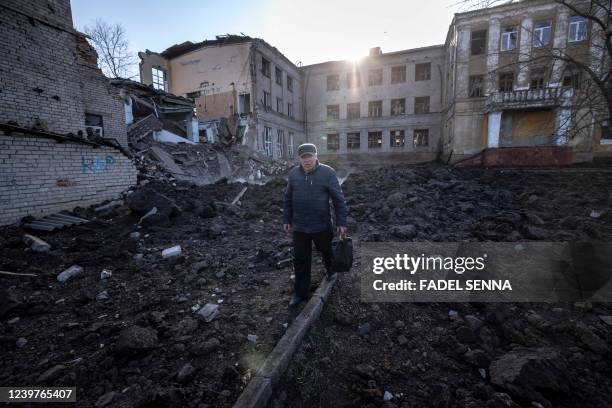 Man walks near a damaged school, next to a police building in Kramatorsk, Donbas Region of eastern Ukraine on April 5, 2022.