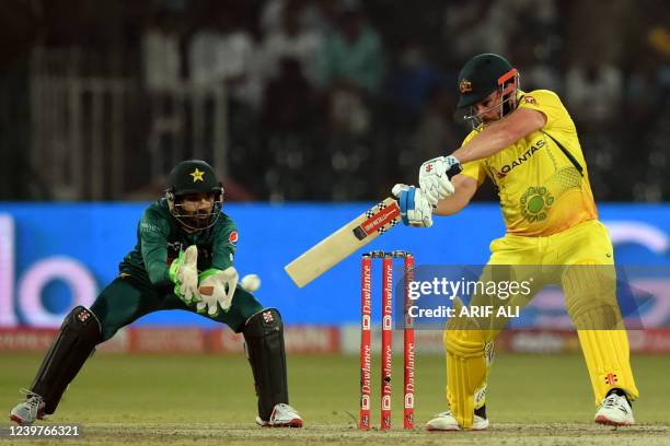 Australia's captain Aaron Finch plays a shot as Pakistan's wicketkeeper Mohammad Rizwan watches during the Twenty20 international cricket match...