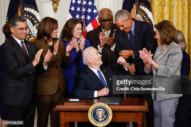 President Joe Biden fist bumps former President Barack Obama after Biden signed an executive order aimed at strengthening the Affordable Care Act...