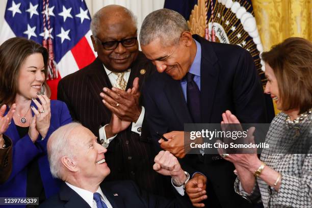 President Joe Biden fist bumps former President Barack Obama after Biden signed an executive order aimed at strengthening the Affordable Care Act...