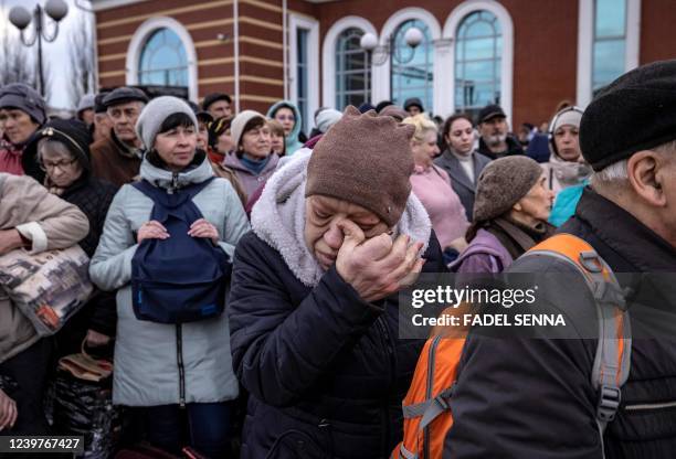 Woman gestures as families wait to board a train at Kramatorsk central station as they flee the eastern city of Kramatorsk, in the Donbass region on...