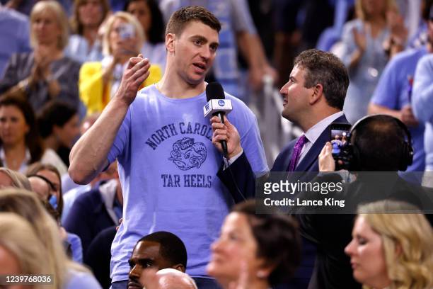 Former North Carolina player Tyler Hansbrough is interviewed by Andy Katz during the game between the North Carolina Tar Heels and the Kansas...
