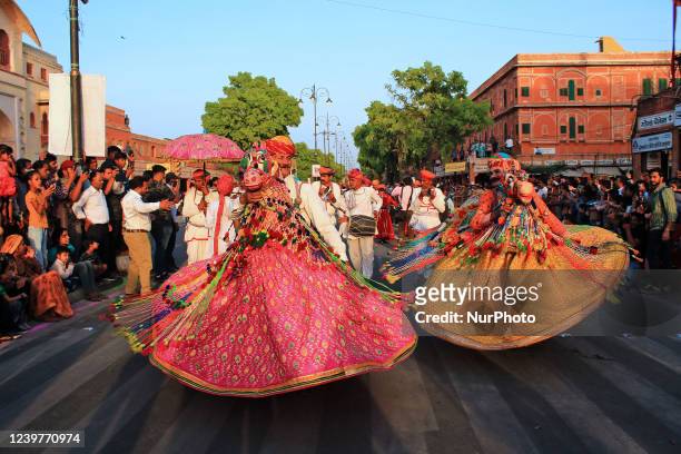 Artists during a traditional Gangaur procession makes way through Tripolia Gate on the occasion of Gangaur festival in Jaipur,Rajasthan , India ,...