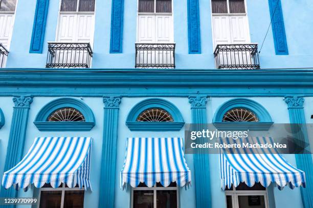 colonial style building in the boulevard, bayamo, cuba - awning stock pictures, royalty-free photos & images