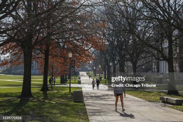 Students walk on the University of Illinois at Urbana-Champaign campus on Thursday, Dec. 9, 2020. The Biden administration has grappled with ending...