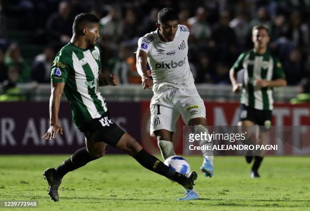 Argentina's Banfield Alejandro Maciel and Brazil's Santos Lucas Henrique Barbosa vie for the ball during their Sudamericana Cup group stage first leg...