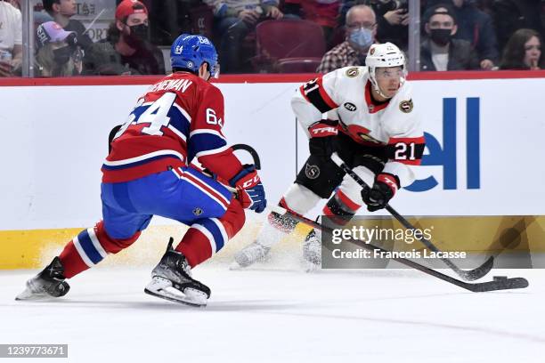 Mathieu Joseph of the Ottawa Senators controls the puck while being challenged by Corey Schueneman of the Montreal Canadiens in the NHL game at the...