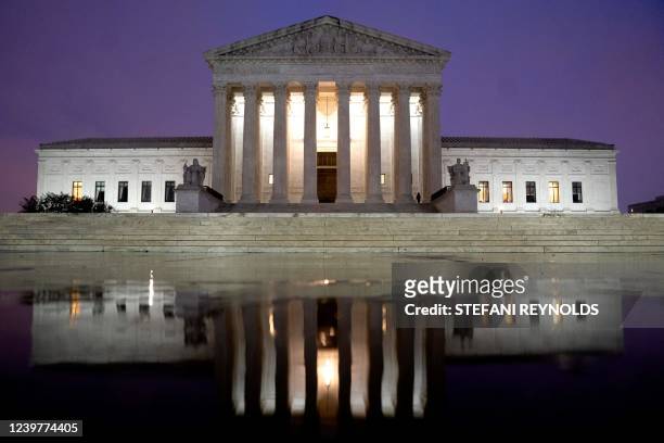 The US Supreme Court is reflected in a puddle of water in Washington, DC, on April 5, 2022.