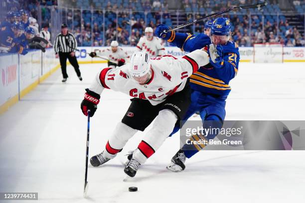 Jordan Staal of the Carolina Hurricanes pushes off from Rasmus Dahlin of the Buffalo Sabres during an NHL game on April 5, 2022 at KeyBank Center in...
