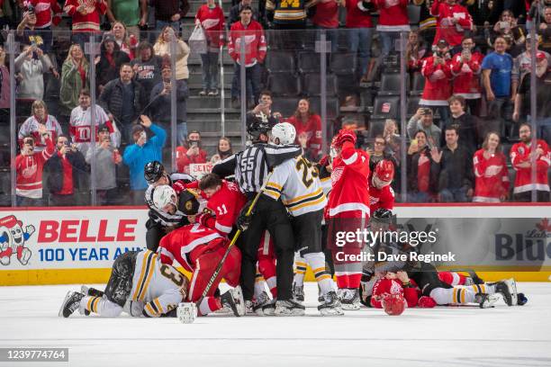 Players from the Boston Bruins and the Detroit Red Wings get into a scrum late in the third period of an NHL game at Little Caesars Arena on April 5,...