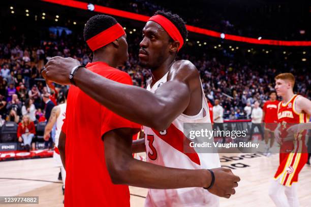 Chris Boucher and Pascal Siakam of the Toronto Raptors hug after the game against the Atlanta Hawks on April 5, 2022 at the Scotiabank Arena in...