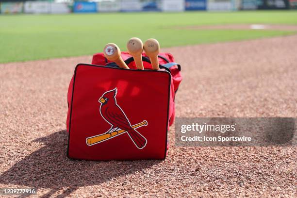 St. Louis Cardinals players bag rests on the infield track while he signs autographs for fans during the spring training game between the St. Louis...