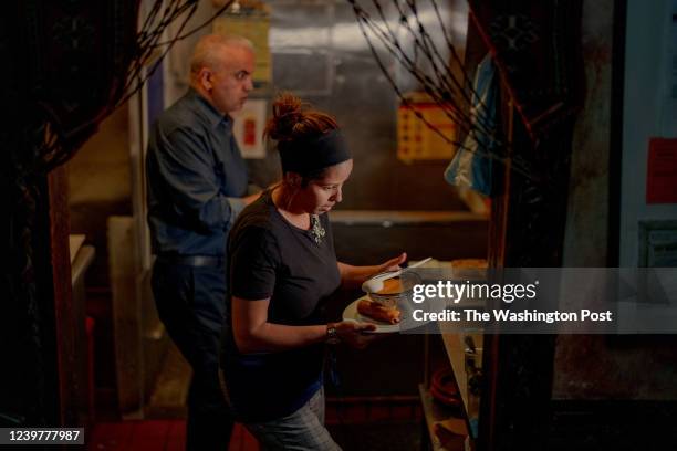 Mehenni Zebentout and Khalida Djeriou, Waiter at Nomad restaurant while working on April 2, 2022 in New York, NY.