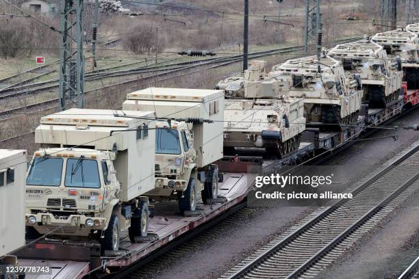 April 2022, Saxony-Anhalt, Magdeburg: A train carrying U.S. Army military vehicles, including M88 armored recovery vehicles, passes through...