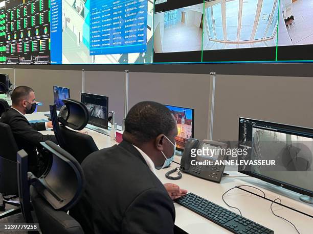 People work on March 28, 2022 at the Aspire security command centre for the FIFA World Cup Qatar 2022, located in the Aspire Zone, near Khalifa...