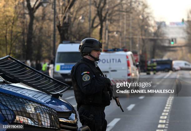 Romanian police forces secure the area around the Russian Embassy to Romania in Bucharest, April 6 after a man rammed his car into the gates of the...