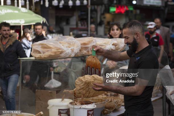 Man prepares traditional food during the holy month of Ramadan in Damascus, Syria on April 04, 2022.