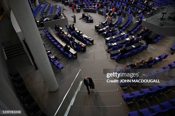 German Chancellor Olaf Scholz leaves the plenary hall after answering questions from parliamentarians during a session at the Bundestag in Berlin on...