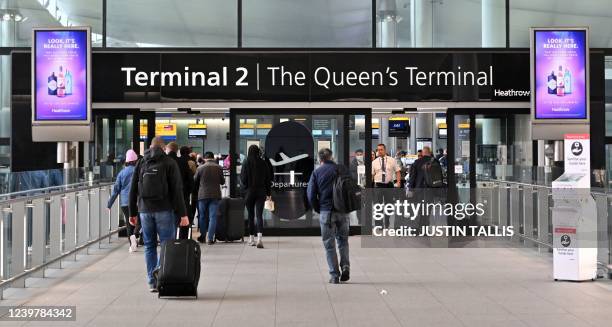 Holidaymakers and travellers arrive at Terminal 2 of London Heathrow Airport in west London, on April 6, 2022. - British Airways on Wednesday...