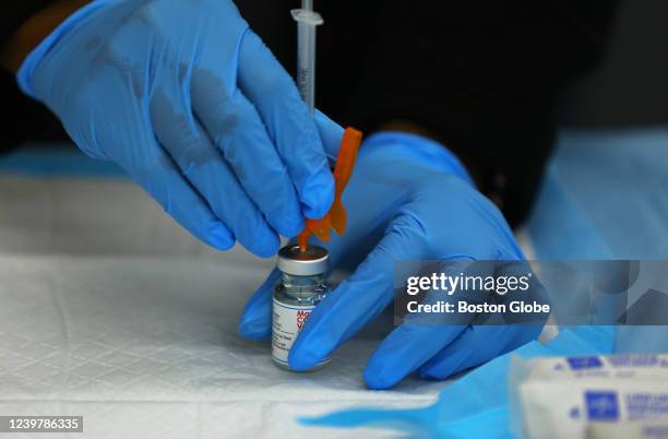 Dose of the Moderna COVID-19 Vaccine is prepared at a COVID-19 testing and vaccination site at the Harvard Street Neighborhood Health Center in...