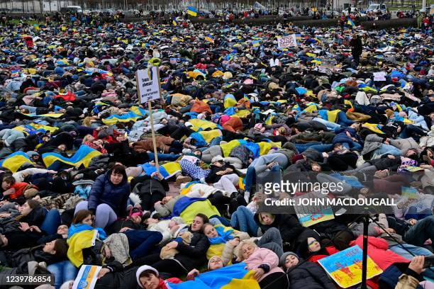 Pro-Ukrainian activists stage a "Die-in" during a protest under the slogan "Stop promising, start acting!" to call for an immediate embargo on oil,...