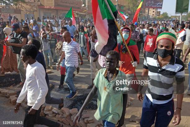 Sudanese protesters march towards the parliament building in Omdurman on April 6 during a rally against military rule on the anniversary of previous...