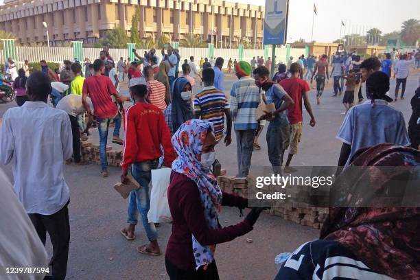 Sudanese protesters barricade outside the parliament building in Omdurman on April 6 during a rally against military rule on the anniversary of...