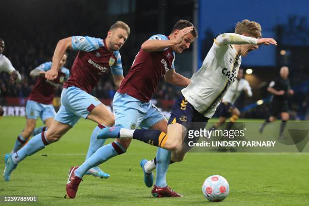 Everton's English striker Anthony Gordon is fouled for a penalty by Burnley's English midfielder Ashley Westwood during the English Premier League...
