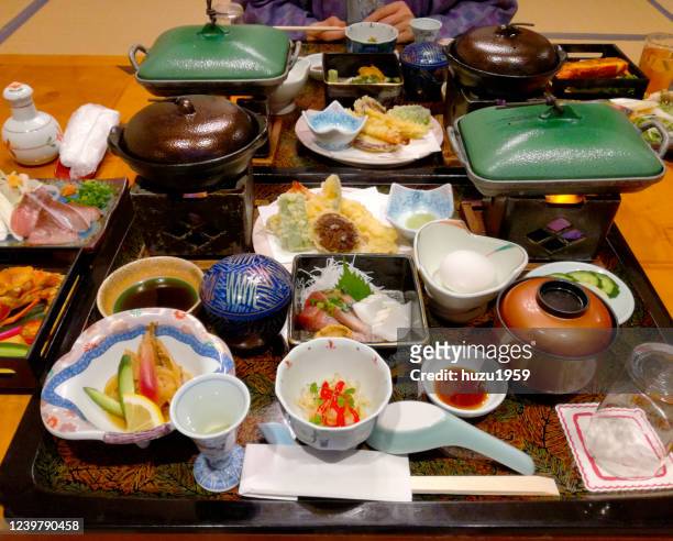 japanese diner served for two people in a traditional japanese hotel (ryokan) - ryokan stock pictures, royalty-free photos & images