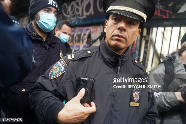 Police officer turns off his body camera as Mayor Eric Adams orders homeless camps removed on April 6, 2022 in New York. - Homeless individuals in...