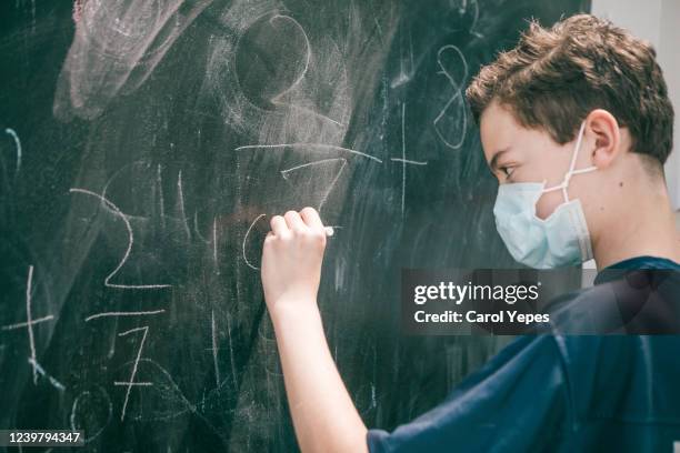 teenager boy wearing protective mask at school - school data imagens e fotografias de stock