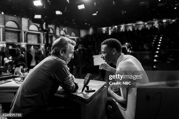 Episode 1275 -- Pictured: Host Seth Meyer talks with actor/comedian Jerrod Carmichael during a commercial break on April 6, 2022 --