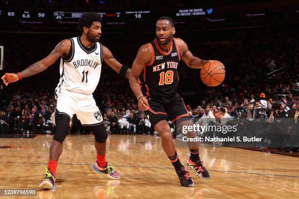 Kyrie Irving of the Brooklyn Nets plays defense on Alec Burks of the New York Knicks during the game on April 6, 2022 at Madison Square Garden in New...