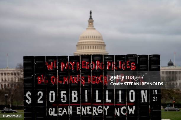 Oil barrels displaying a message calling for clean energy are seen in front of the US Capitol in Washington, DC, on April 6, 2022.