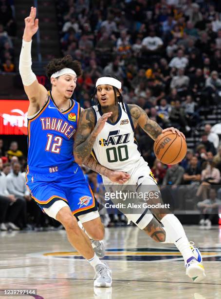 Jordan Clarkson of the Utah Jazz drives into Lindy Waters III of the Oklahoma City Thunder during the first half of a game at Vivint Smart Home Arena...