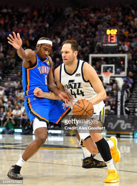 Bojan Bogdanovic of the Utah Jazz drives into Melvin Frazier Jr. #6 of the Oklahoma City Thunder during the first half of a game at Vivint Smart Home...
