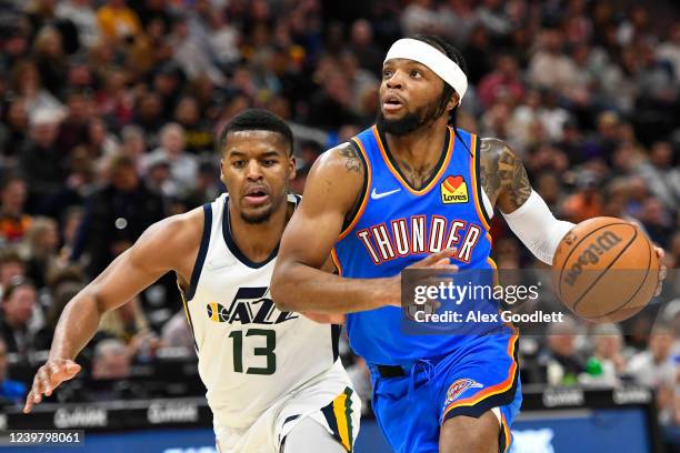 Zavier Simpson of the Oklahoma City Thunder drives past Jared Butler of the Utah Jazz during the second half of a game at Vivint Smart Home Arena on...