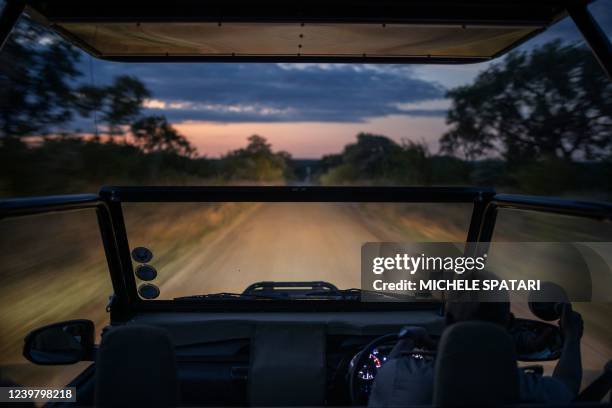 Game ranger from the Kruger Shalati hotel drives an open safari truck during a game drive through the park in Skukuza, Kruger National Park, on April...