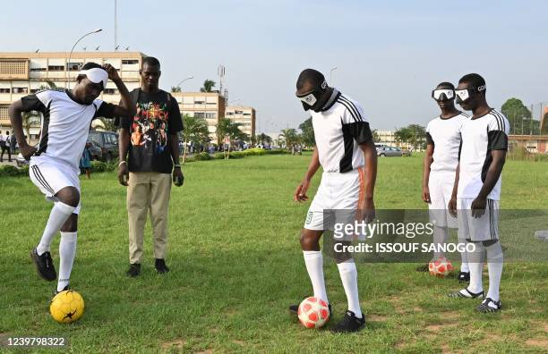 Blind and visually impaired Ivorian football players take part in a training session at the Felix Houphouet-Boigny University in Abidjan on February...