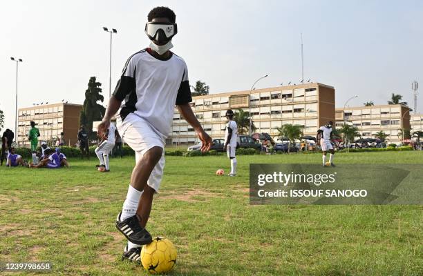 Blind and visually impaired Ivorian football players take part in a training session at the Felix Houphouet-Boigny University in Abidjan on February...