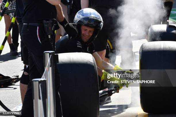 Mercedes' crew members practice pit stops outside the garage at the Albert Park Circuit in Melbourne on April 7 ahead of the 2022 Formula One...