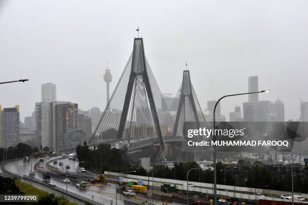 Traffic make its way in to the city on the ANZAC Bridge during rainfall in Sydney on April 7 as inclement weather triggered evacuation orders in...