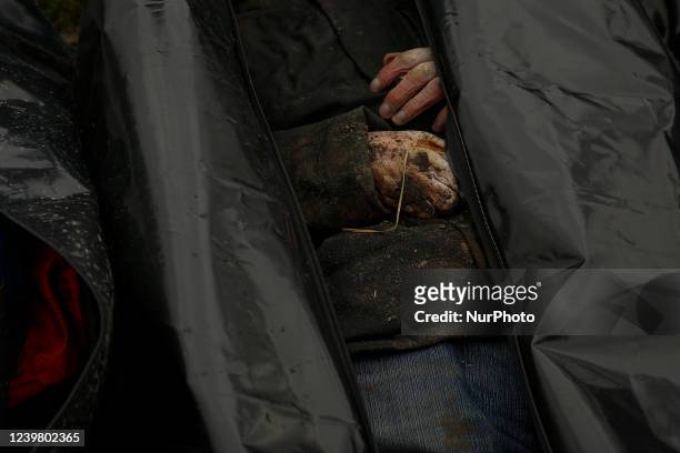 Image contains graphic content) A view of the corpse of a civilian killed, before being transported to the morgue, in the cemetery in Bucha, on the...