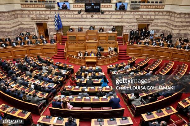 Greek MP's listen as Ukraine's President Volodymyr Zelensky gives a virtual address to Greek Parliament in Athens on April 7, 2022. - Greece is to...