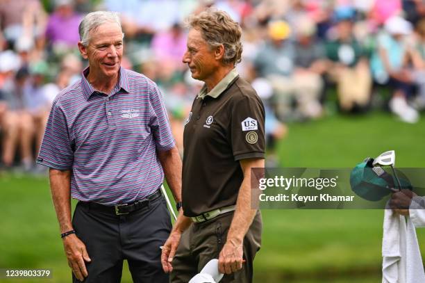 Larry Mize smiles with Bernhard Langer of Germany during the Par Three Contest prior to the Masters at Augusta National Golf Club on April 6 in...