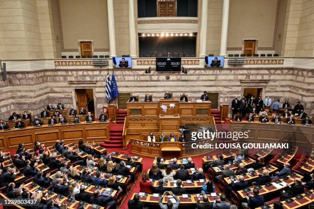 Greek MP's listen as Ukraine's President Volodymyr Zelensky gives a virtual address to Greek Parliament in Athens on April 7, 2022. - Greece is to...