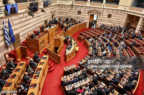 Greek MP's listen to Ukraine's President Volodymyr Zelensky during his virtual address to the Greek Parliament in Athens on April 7, 2022. - Greece...