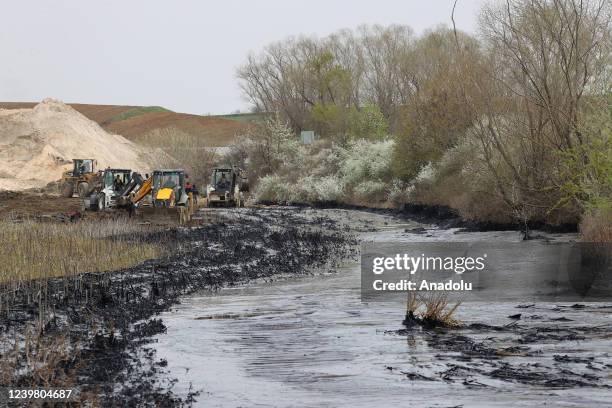 General view of the pitch leaked area from the pool at asphalt construction site during the cleaning works in Edirne, Turkiye on April 7, 2022.