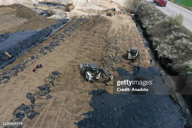 An aerial view of the pitch leaked area from the pool at asphalt construction site during the cleaning works in Edirne, Turkiye on April 7, 2022.